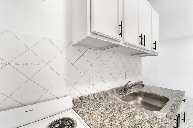 a view of a storage & utility room with refrigerator