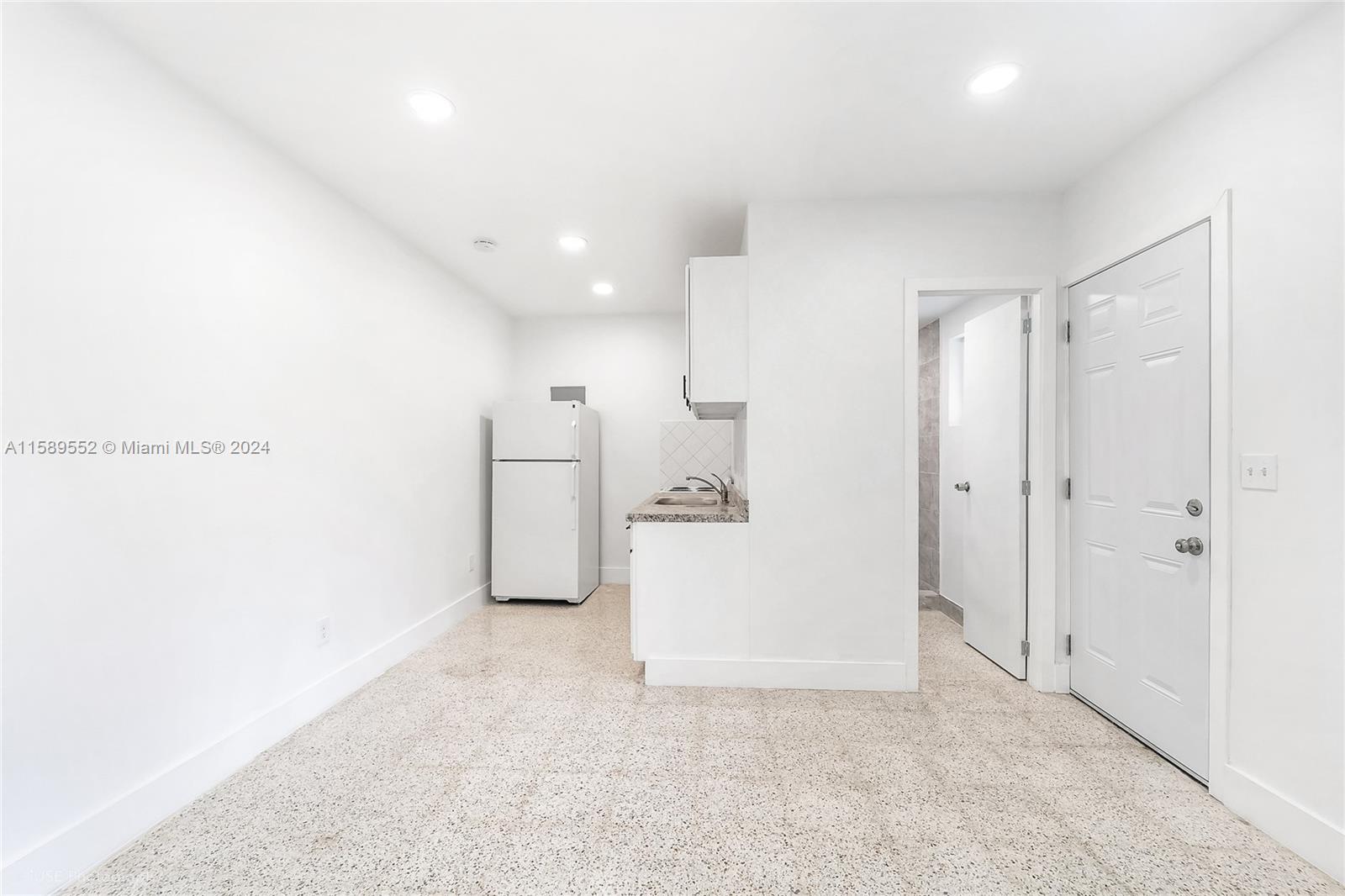 2130 Northwest 28th Street Miami, FL 33142 - Photo 34 of 48 a view of a storage & utility room with refrigerator
