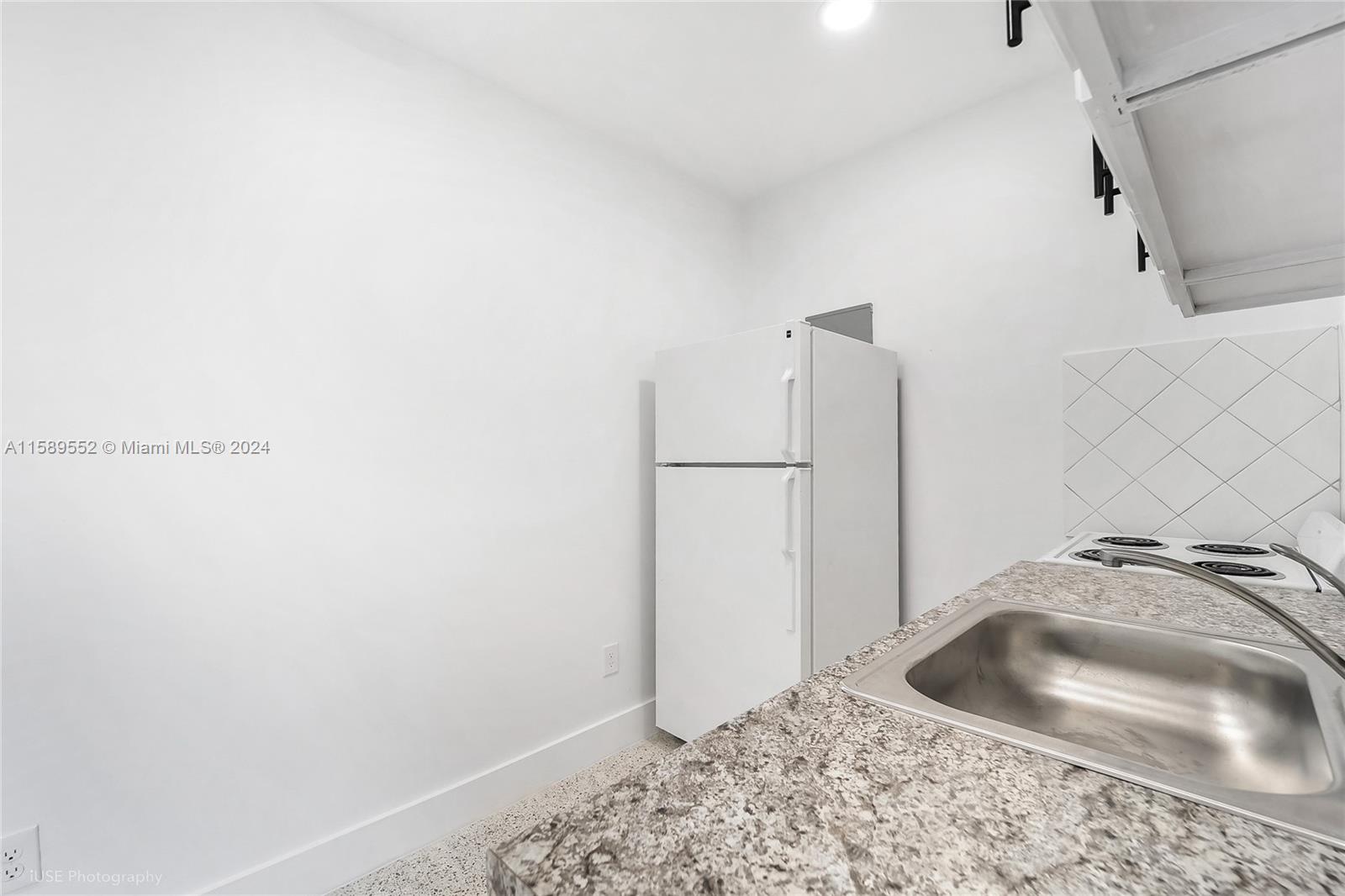 2130 Northwest 28th Street Miami, FL 33142 - Photo 36 of 48 a bathroom with a sink and a mirror