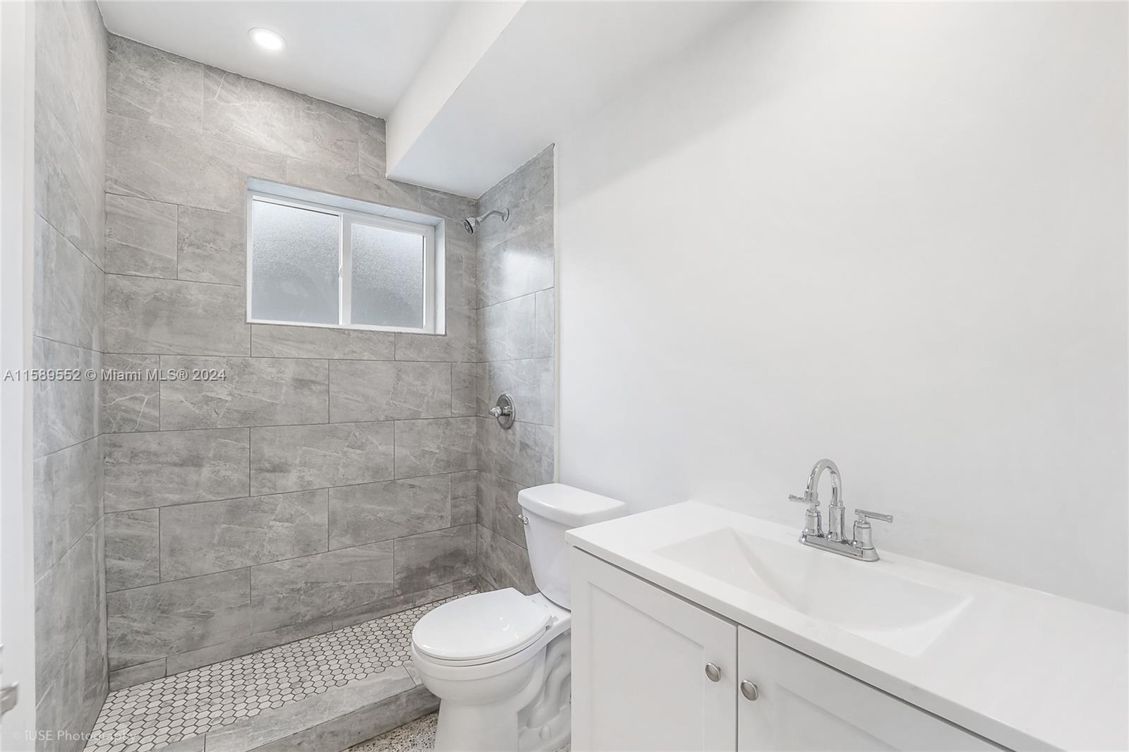 2130 Northwest 28th Street Miami, FL 33142 - Photo 45 of 48 a bathroom with a sink a toilet and a mirror