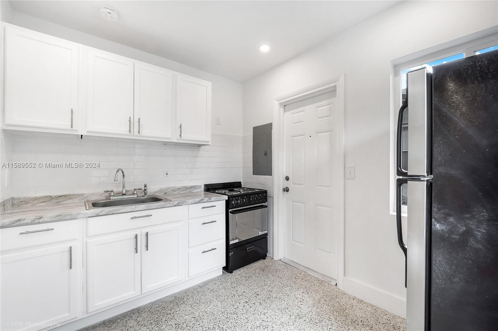 2130 Northwest 28th Street Miami, FL 33142 - Photo 46 of 48 a kitchen with stainless steel appliances granite countertop a refrigerator sink and cabinets