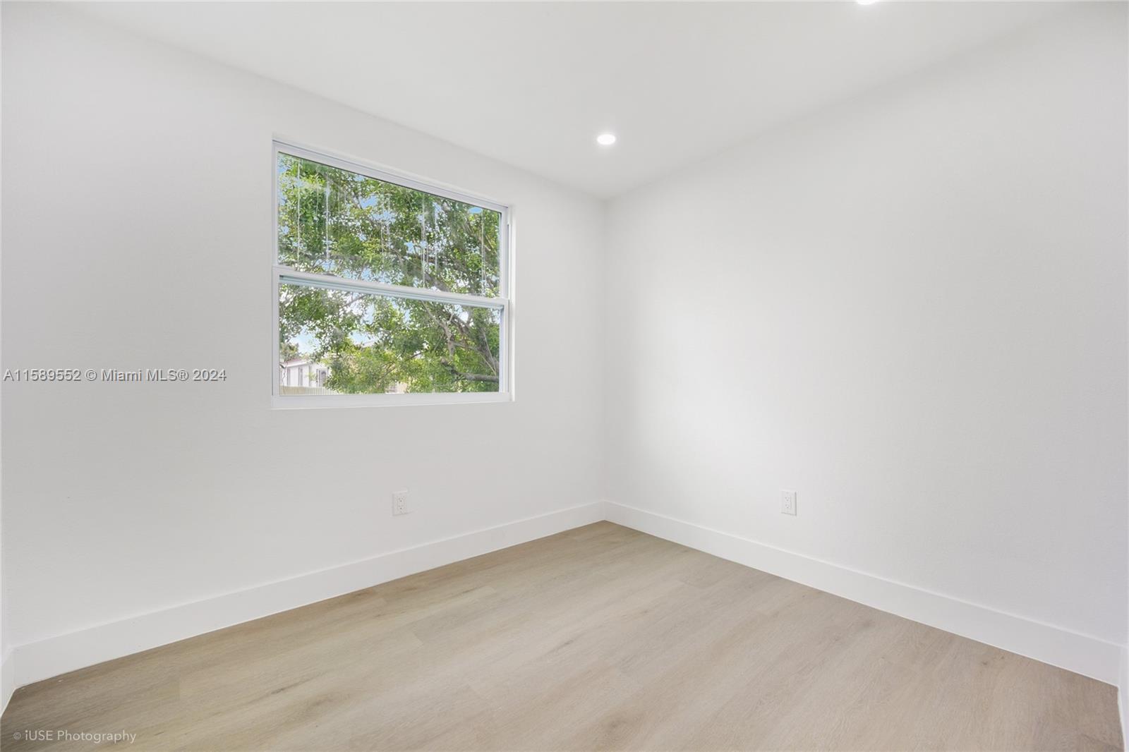 2130 Northwest 28th Street Miami, FL 33142 - Photo 8 of 48 an empty room with a window