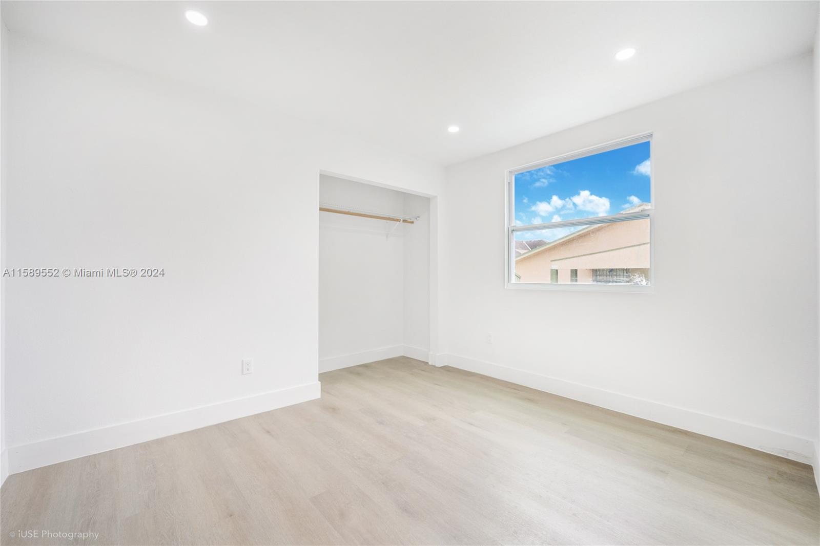 2130 Northwest 28th Street Miami, FL 33142 - Photo 9 of 48 an empty room with a painting on the wall