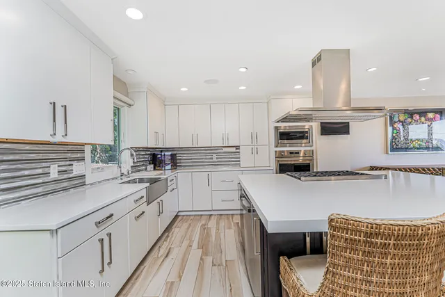 a bathroom with a sink a vanity and a potted plant