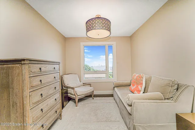 a view of roof deck with seating space and wooden floor