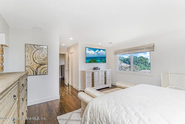 a view of patio with chairs and table under an umbrella