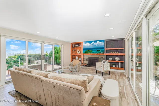 a living room with furniture a rug and a large window