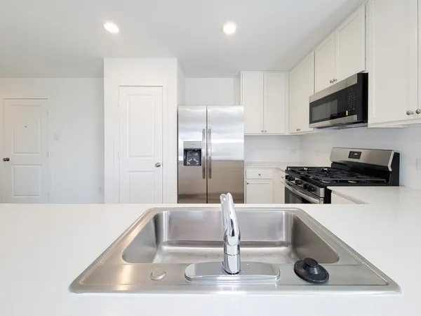 a kitchen with a sink a stove and microwave