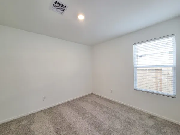 an empty room with a empty space and windows