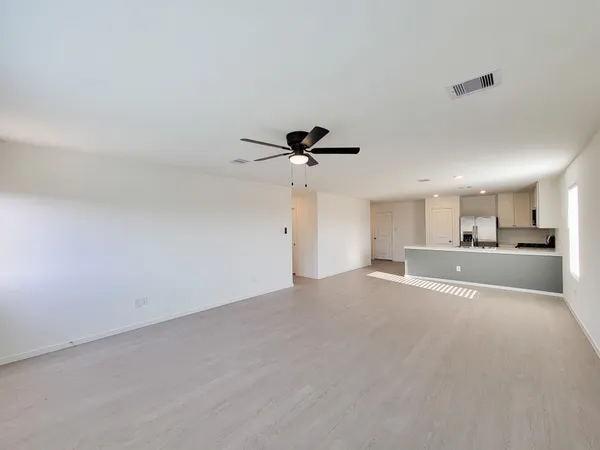 a view of a kitchen with a sink and a chandelier fan