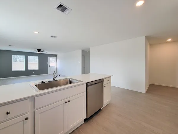 a kitchen with a sink and cabinets