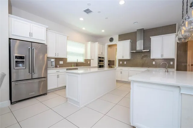 a kitchen with stainless steel appliances granite countertop a sink and a stove