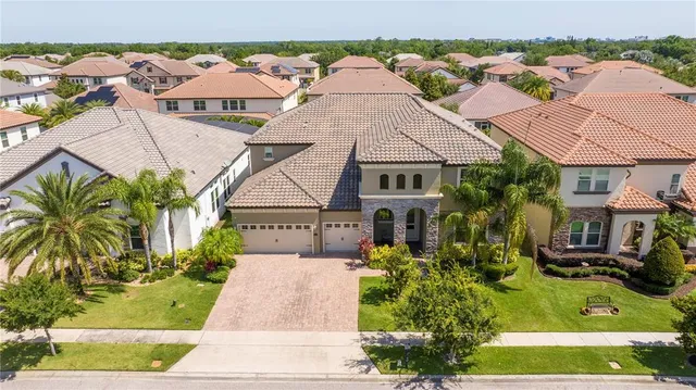 an aerial view of multiple houses with a yard