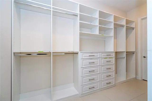 a spacious bedroom with a bed and a table