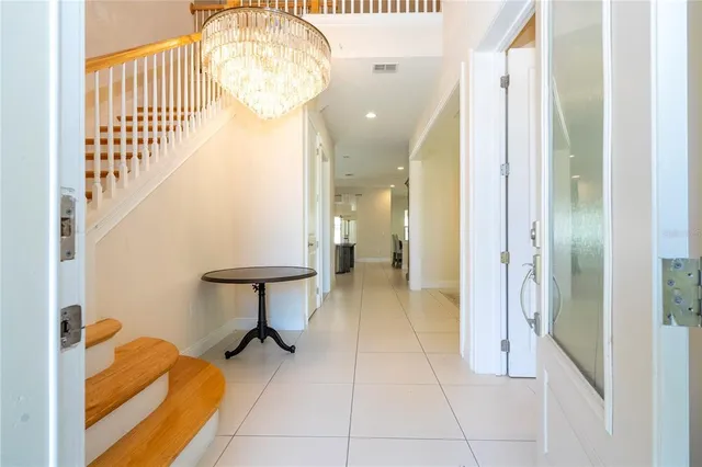 a view of a room with furniture and a chandelier