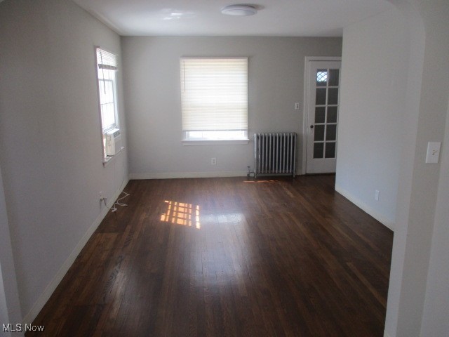 3703 Bainbridge Road Cleveland Heights, OH 44118 - Photo 4 of 16 Empty room with radiator and dark wood finished floors