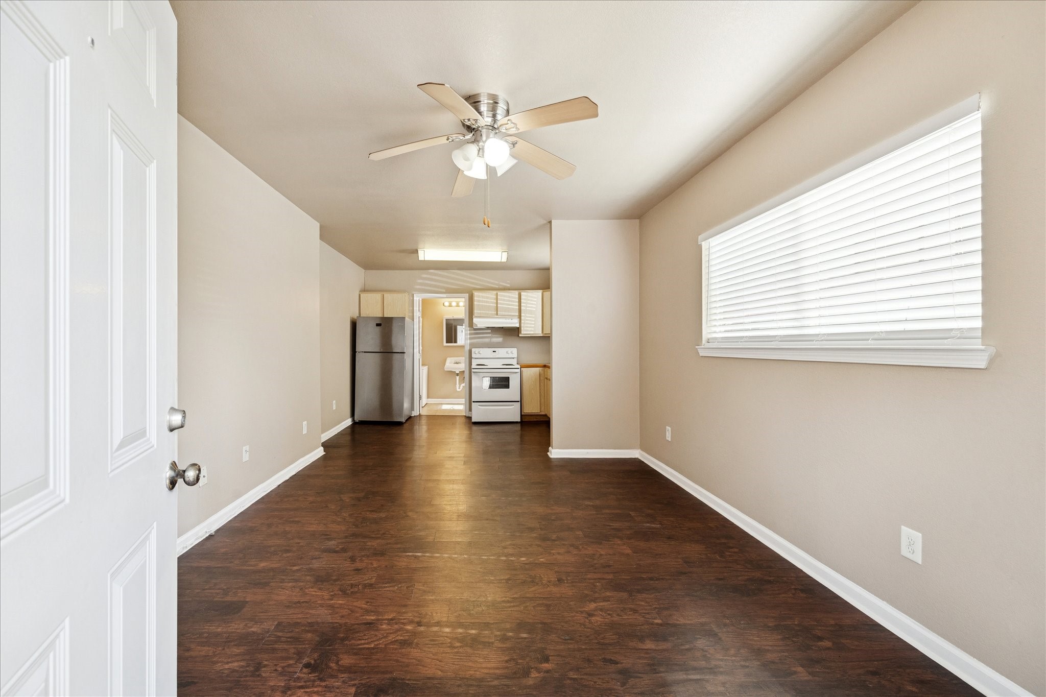 wooden floor in an empty room with a window