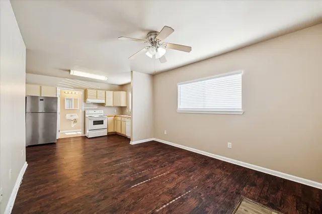 a view of a kitchen with wooden floor and a ceiling fan