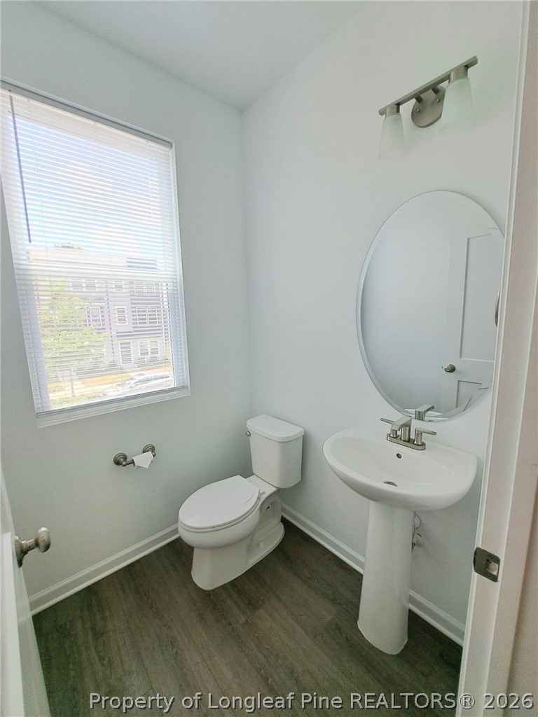 1939 Robin Hill Lane Raleigh, NC 27610 - Photo 14 of 25 a white toilet sitting next to a bathroom sink