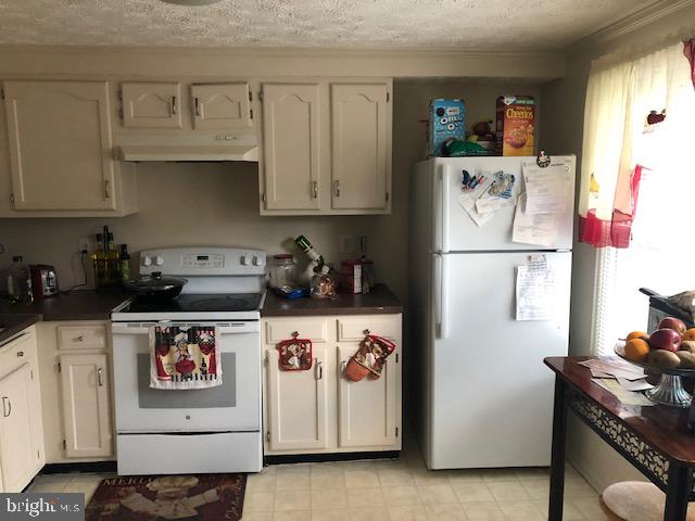 7516 Mandan Road Greenbelt, MD 20770 - Photo 12 of 15 a white refrigerator freezer sitting inside of a kitchen