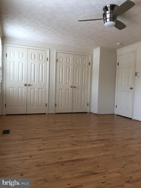 7516 Mandan Road Greenbelt, MD 20770 - Photo 14 of 15 a view of an empty room with wooden floor