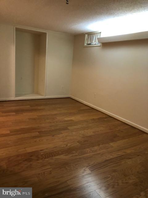 7516 Mandan Road Greenbelt, MD 20770 - Photo 3 of 15 a view of an empty room with wooden floor and a window