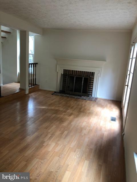 7516 Mandan Road Greenbelt, MD 20770 - Photo 8 of 15 a view of empty room with wooden floor and fireplace