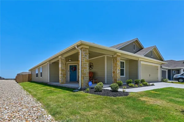 a view of a house with backyard porch and garden