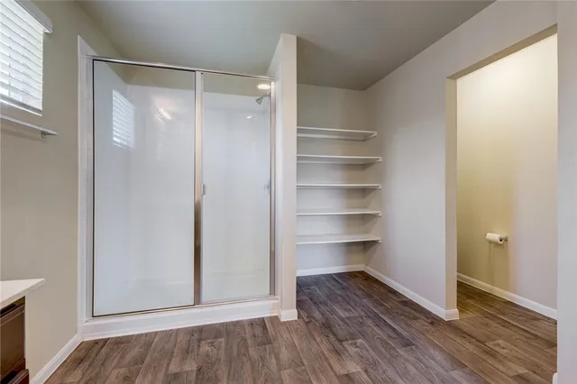 a view of walk in closet with empty racks