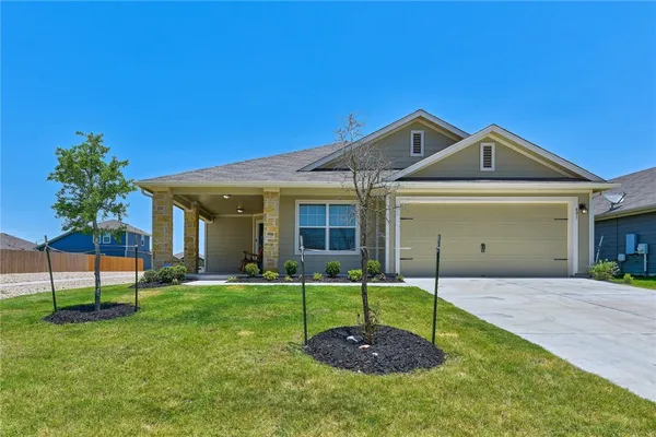 a front view of a house with a yard