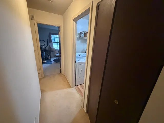 a view of a hallway with wooden shelves