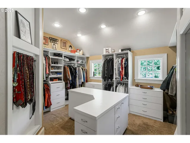 a kitchen with stainless steel appliances kitchen island granite countertop a refrigerator and a sink