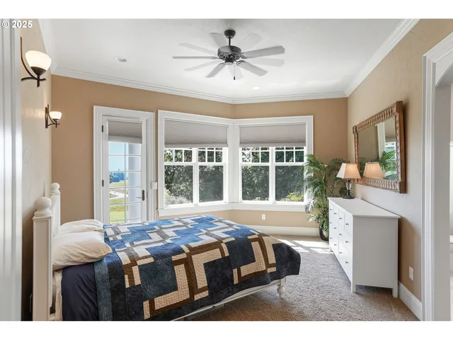 a living room with a bed furniture and a large window