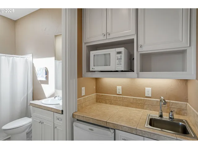 a bathroom with a sink a toilet and vanity