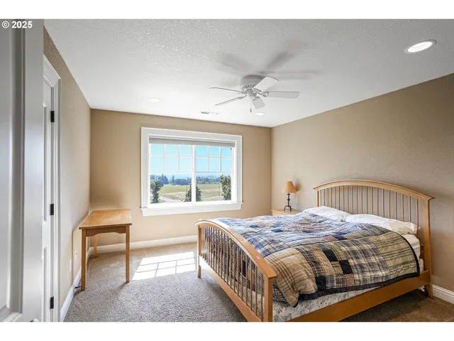 a bedroom with a bed a chandelier and a window