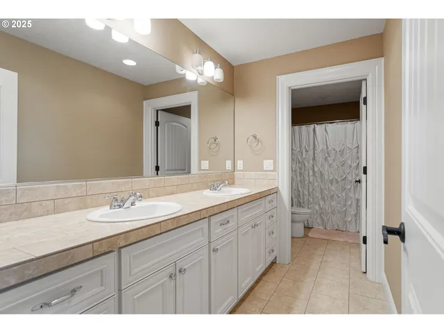 a bathroom with a granite countertop sink mirror and double