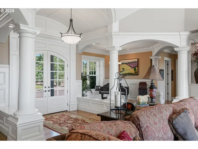 a living room with a bed furniture and a chandelier
