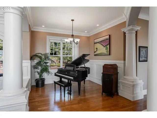 a living room with furniture dining table and a wooden floor