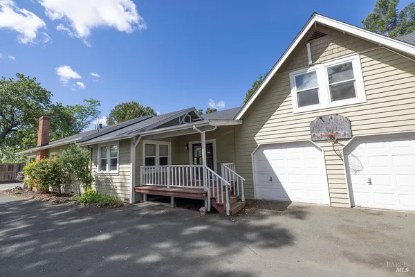 a view of a house with a yard and plants