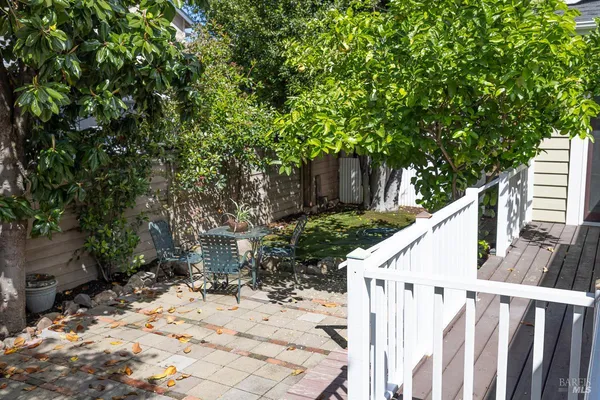 a view of patio with table and chairs and potted plants