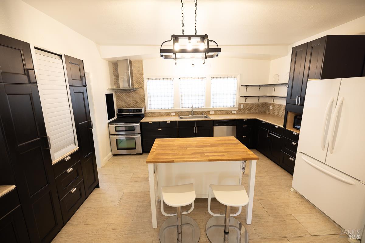 1685 West College Avenue Santa Rosa, CA 95401 - Photo 19 of 45 a kitchen with stainless steel appliances a refrigerator sink and stove