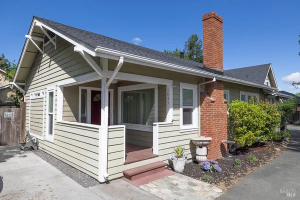 a view of a house with a yard and plants