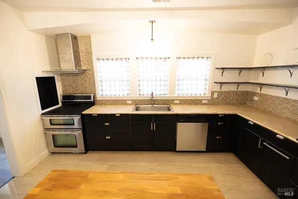 a kitchen with a sink and a refrigerator