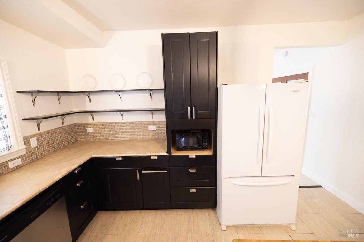 1685 West College Avenue Santa Rosa, CA 95401 - Photo 22 of 45 a kitchen with a sink and a refrigerator
