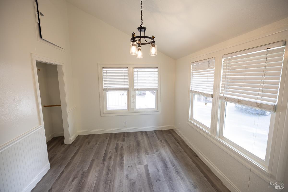 1685 West College Avenue Santa Rosa, CA 95401 - Photo 23 of 45 a view of an empty room with wooden floor and a window