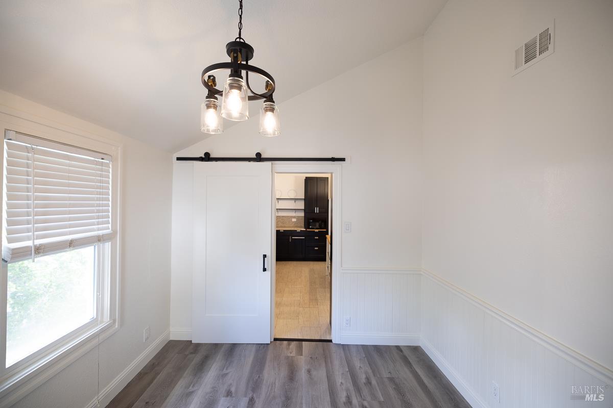 1685 West College Avenue Santa Rosa, CA 95401 - Photo 24 of 45 a room with wooden floor and windows