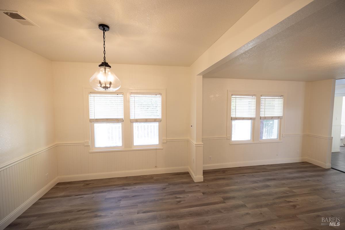 1685 West College Avenue Santa Rosa, CA 95401 - Photo 25 of 45 a view of an empty room with wooden floor and a window