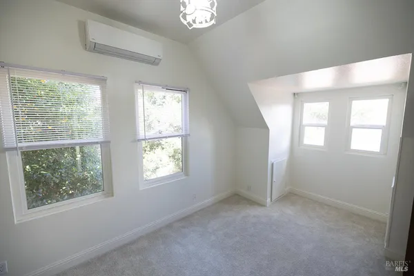 an empty room with windows and closet