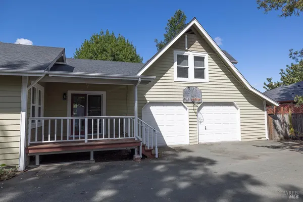 a front view of a house with a garden