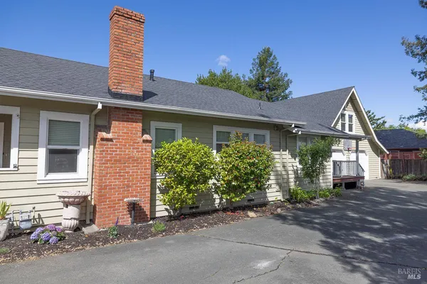 a view of a house with a yard and garage